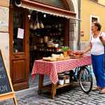 **Prompt:** A vibrant, bustling neighborhood street market in Italy filled with people bartering goods and services. Focus on the diversity of items being exchanged: homemade jams, yoga lessons advertised on a chalkboard, a repaired bicycle, and upcycled furniture. The overall mood is cheerful and community-focused, emphasizing the revival of manual skills. Include details like cobblestone streets and classic Italian architecture in the background.